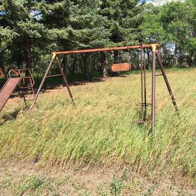 Next tee box is beside this old swing set, shoot over the trees.
