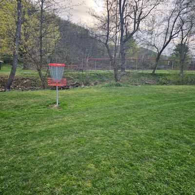 Hole 9's basket w/ it's creek backstop...