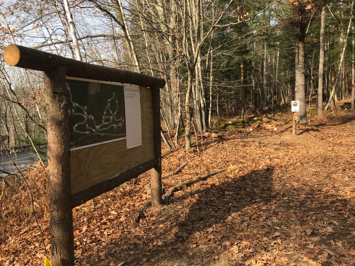 Sign board with hole one in the background.