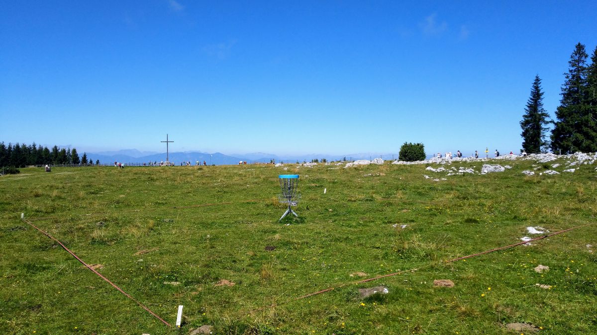 Hole 17 (Island Hole) with summit cross in the background