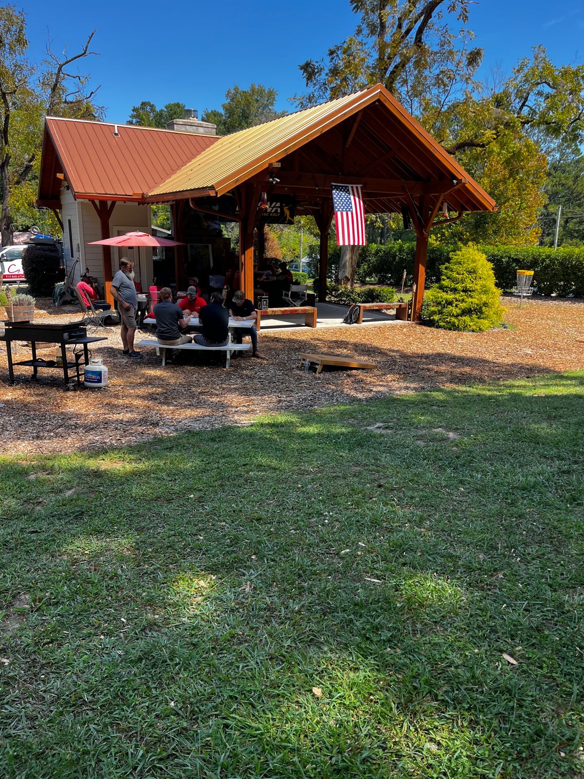 Pavilion area with TVs, practice basket and net, and bathroom