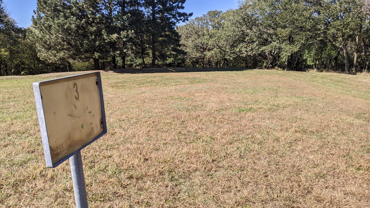 #3 Hole.  Basket over the hill to the right of trees ahead.
