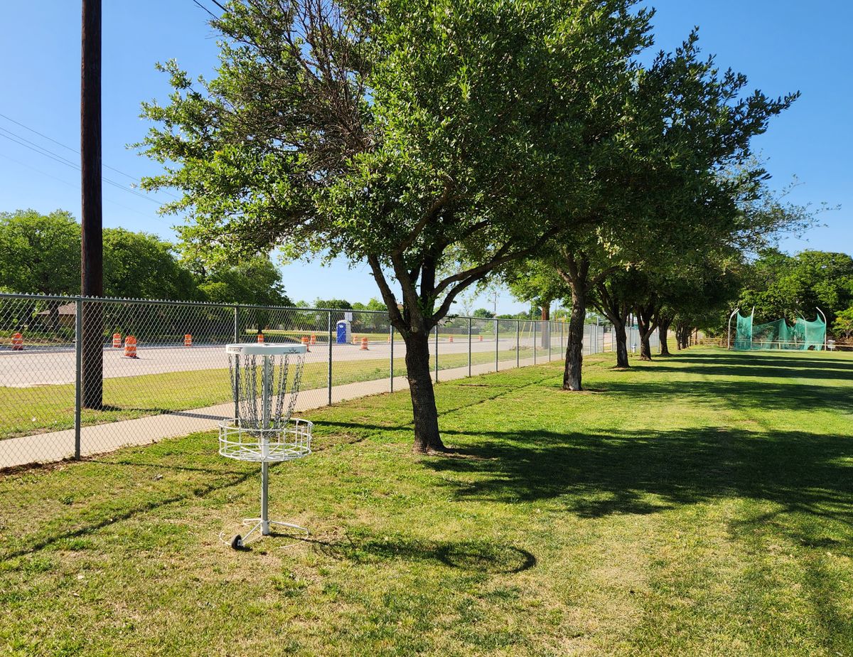 Basket in practice field by fence