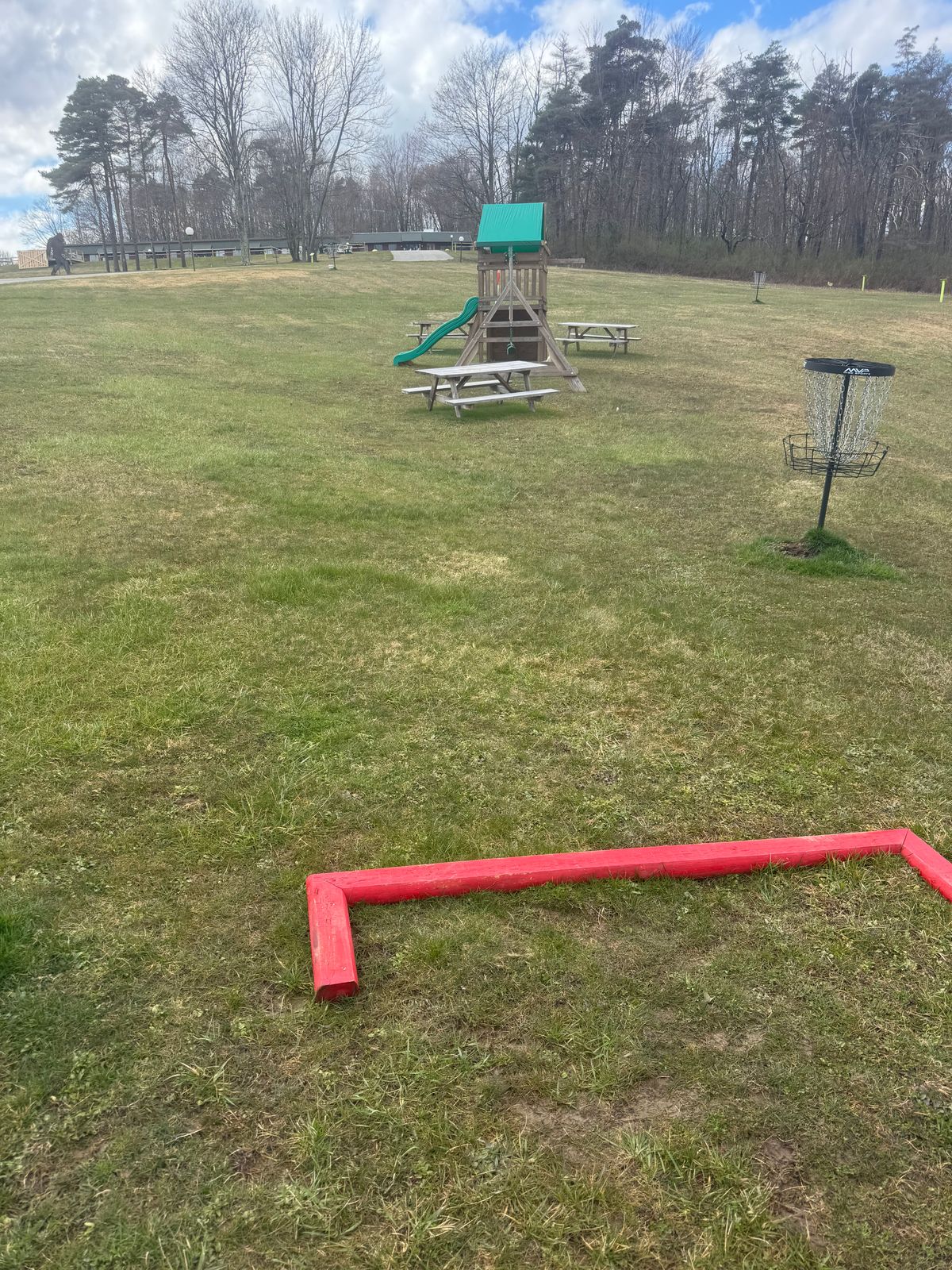 Tee box hole 1,  with hole 9 basket nearby.