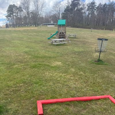 Tee box hole 1,  with hole 9 basket nearby.
