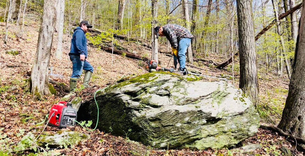 Drilling the holes to anchor hole 11 basket into rock.