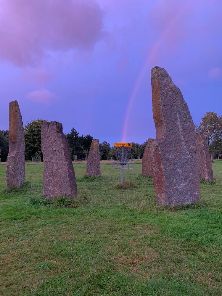A rainbow aligns with the stone circle on Druid’s Dilemma. 
📷: Jason McNeice