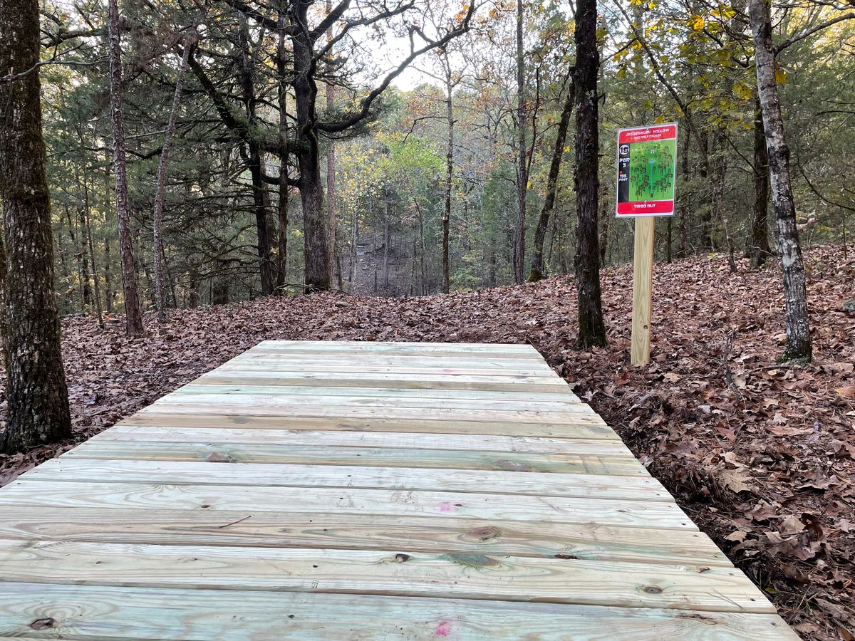 Hole 18 “Tired Out” Tee pad and sign