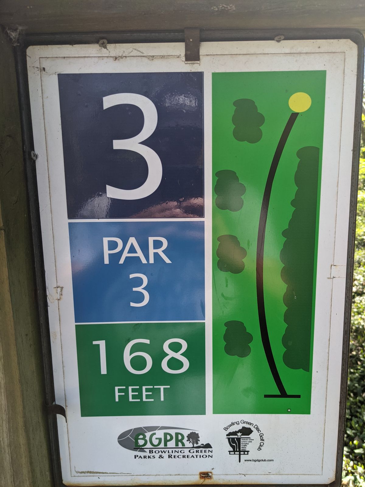 A short hole that demands precision, not length.  Thick woods line the right side to the tributary making a hyzer shot difficult.  Several guardian trees as you approach the green and the steep slope mean no disc is safe until it stops.