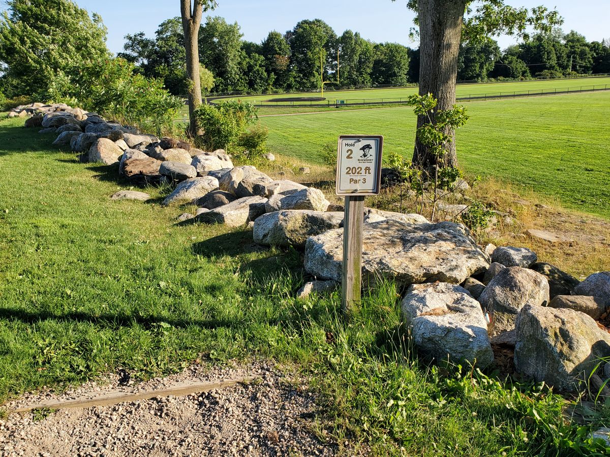 This hole is over the rocks, down the hill. If you zoom in you can see it behind the left tree in this photo. It was a fun little hole.