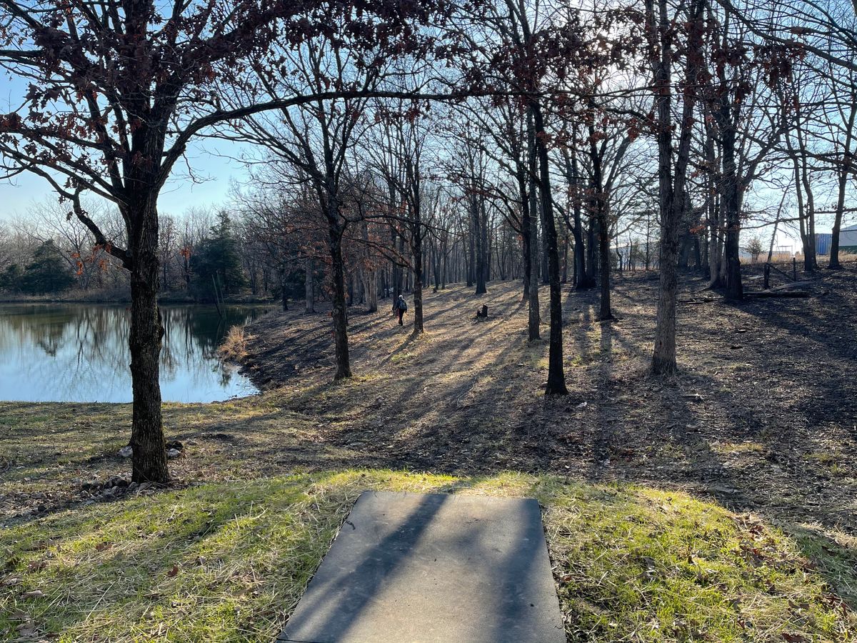 Hole 4 view wooded with clear fairway with danger on the left and tight woods on right.