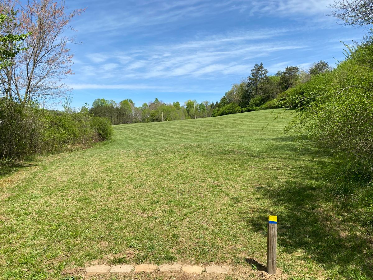 Hole 18. Wide open, uphill. Lake far left.