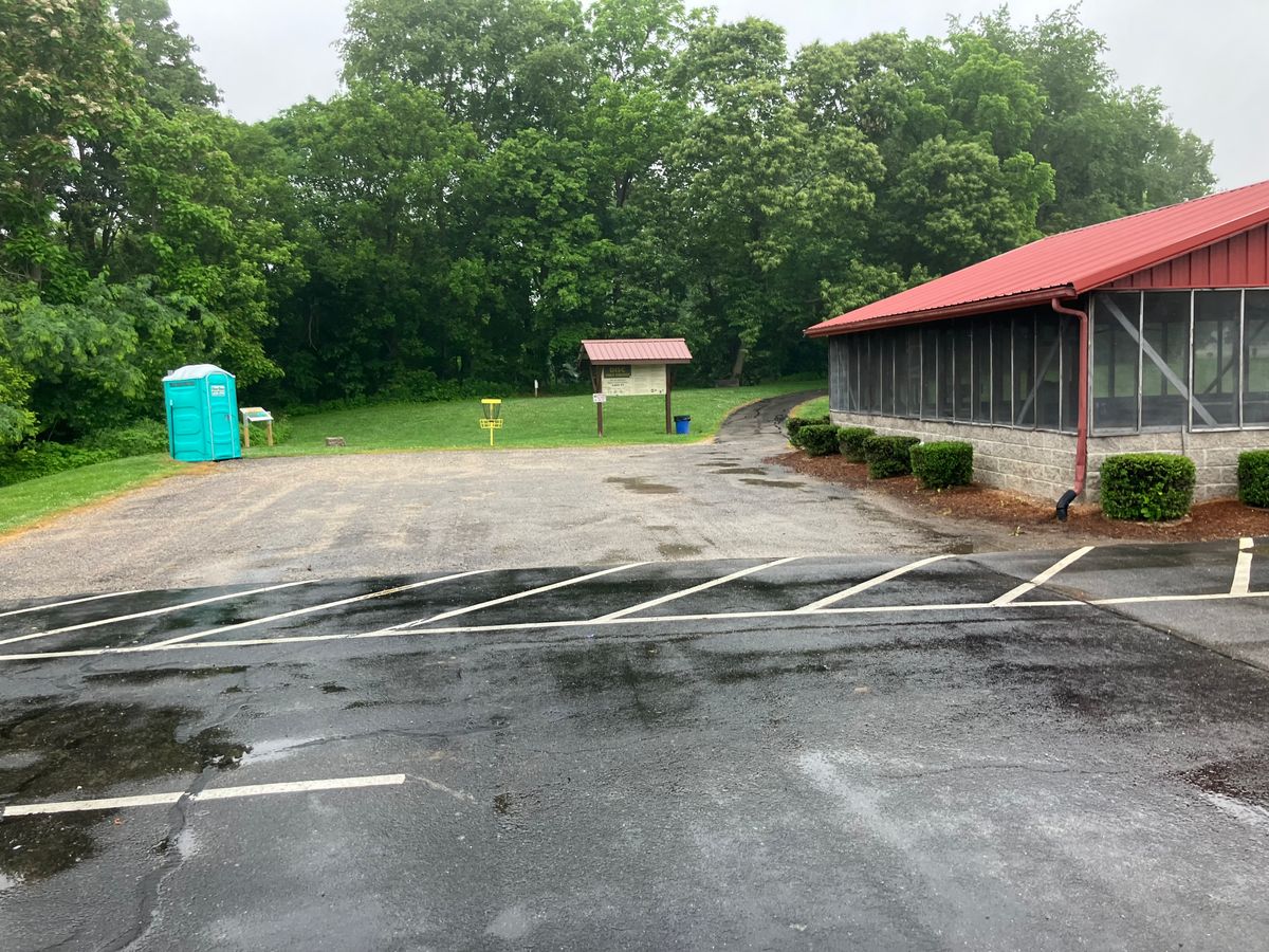 Park is on the left of the Red Roofed Shelter. Practice basket and the PortaJohn are next to hole 1
