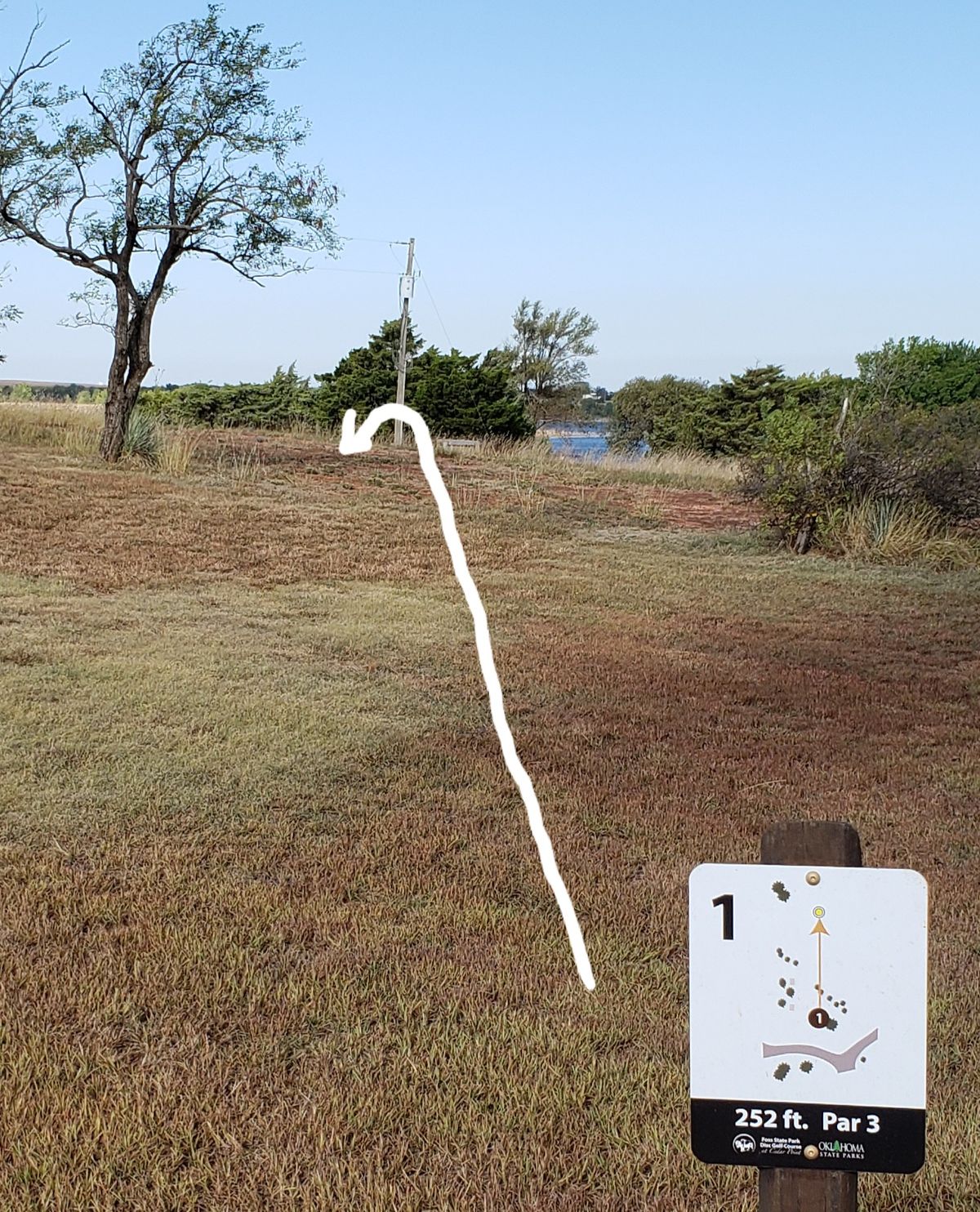 Over the rise, short/left of the pole
