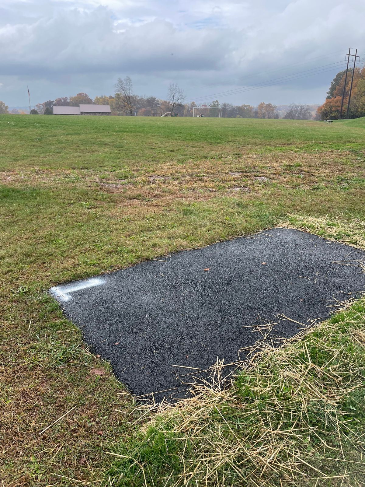 Hole one tee pad looking back at Eagles Nest pavilion.