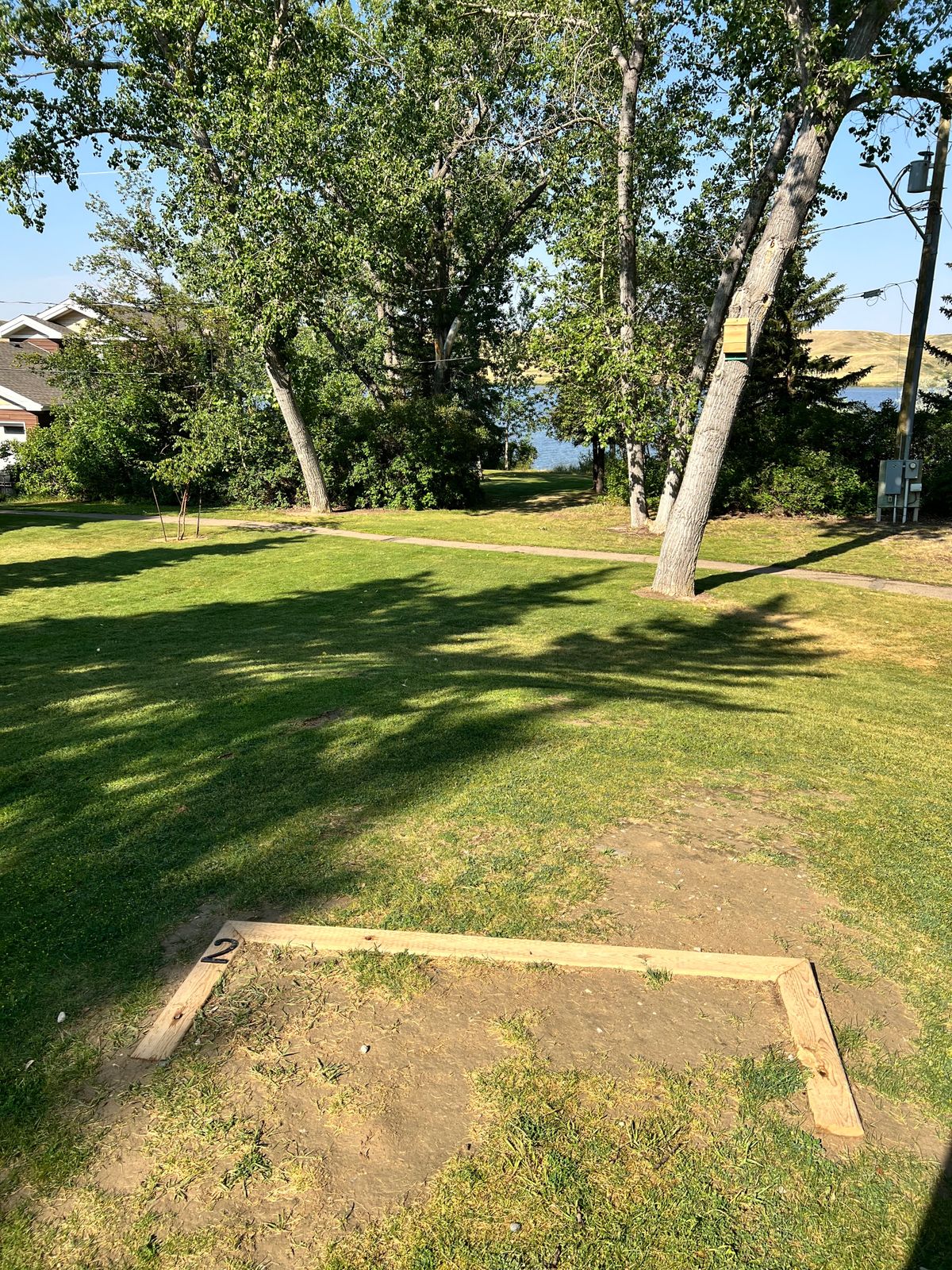 Hole 2. Mandatory to go through gap in trees. Small dogleg left. Watch for other park users on parhs