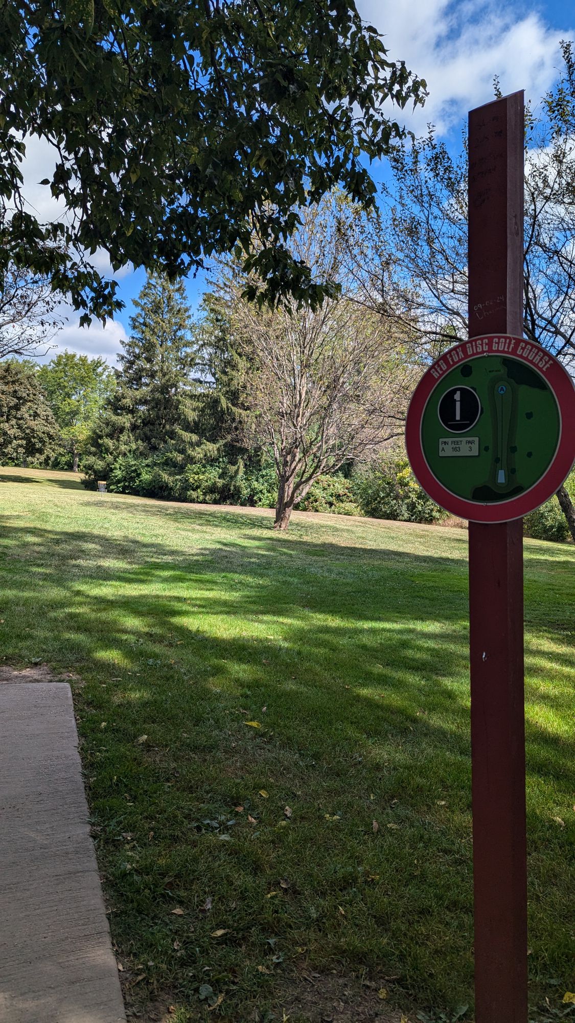Hole 1 signage and basket in the distance