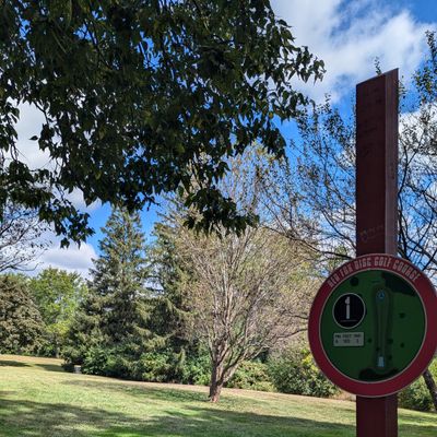 Hole 1 signage and basket in the distance