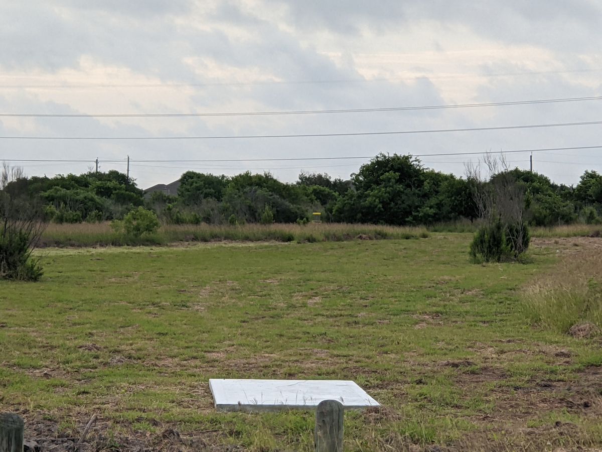Hole 1 teebox, with basket in the distance.
