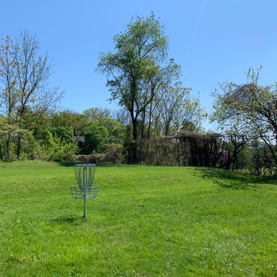 Hole 2 basket. Hole 3 tee is to the right by fence