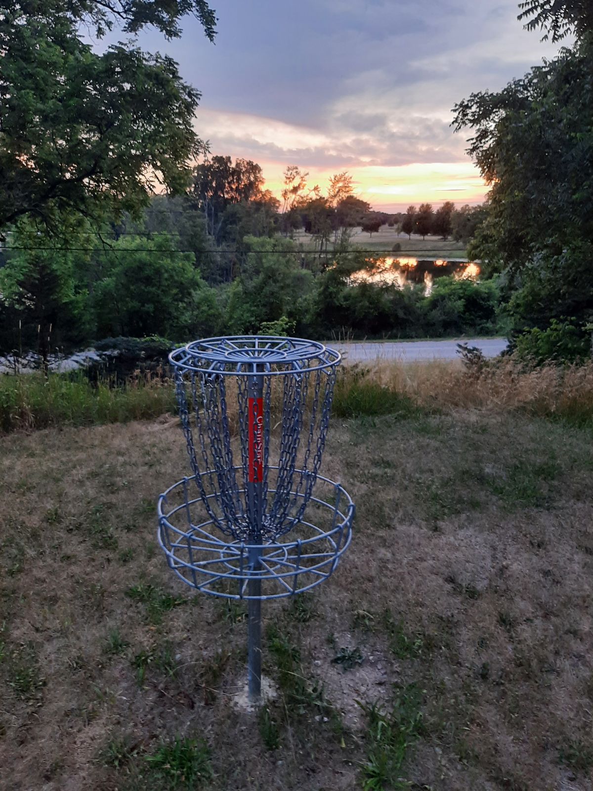 Hole 15 looking out over the lake. There used to be an abandoned house on this location and you can still see the fieldstone retaining walls, a staircase that used to go from a deck down to the drive, and a few other remnants. 