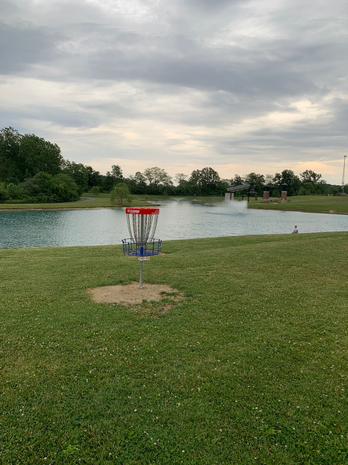 Practice basket with fishing pond beyond.