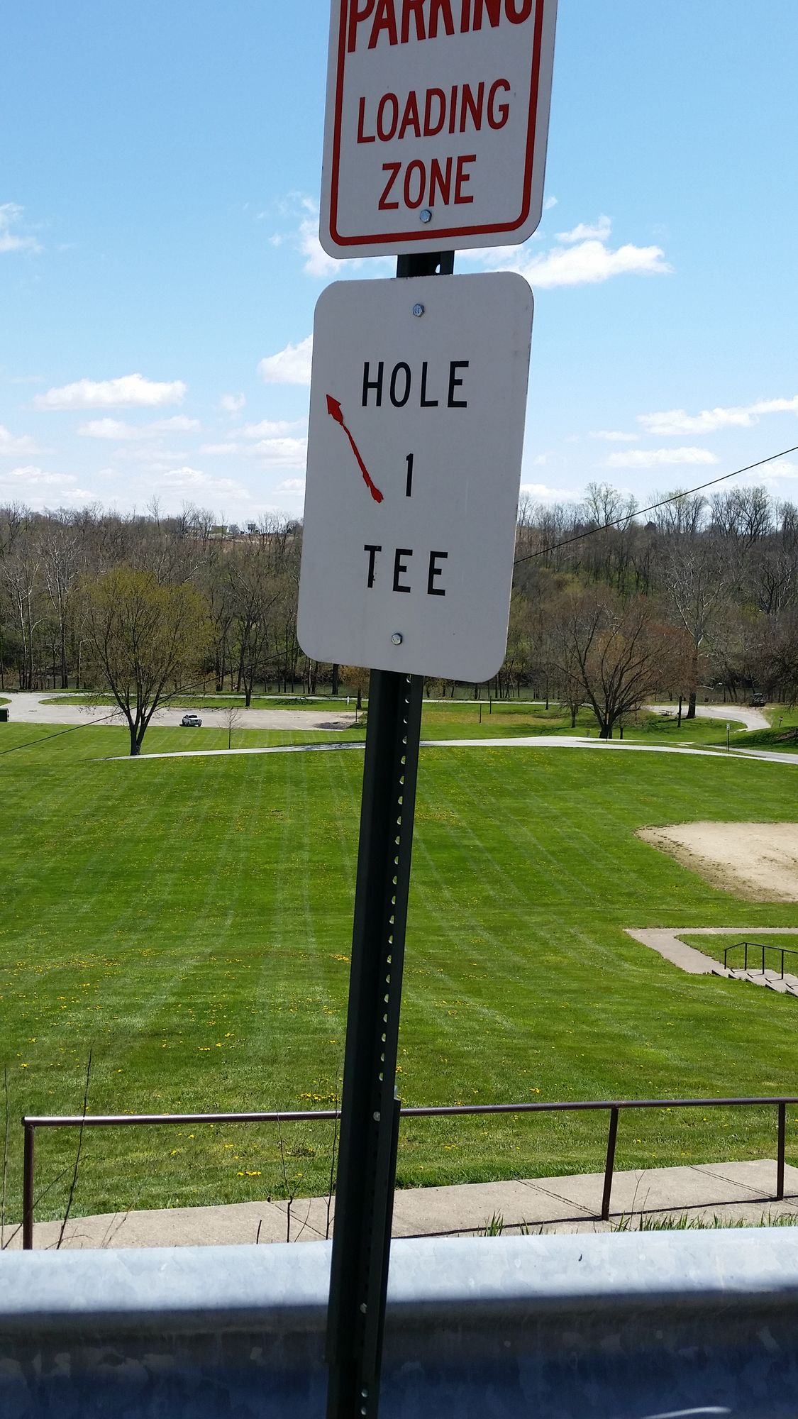 Hole one tee up in the parking lot behind businesses.
