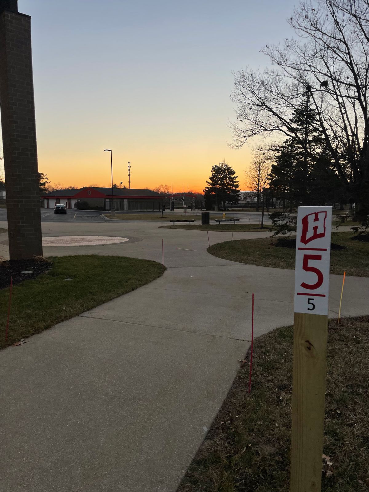 White tee pad for the “island hole” - hole 5 at sunset