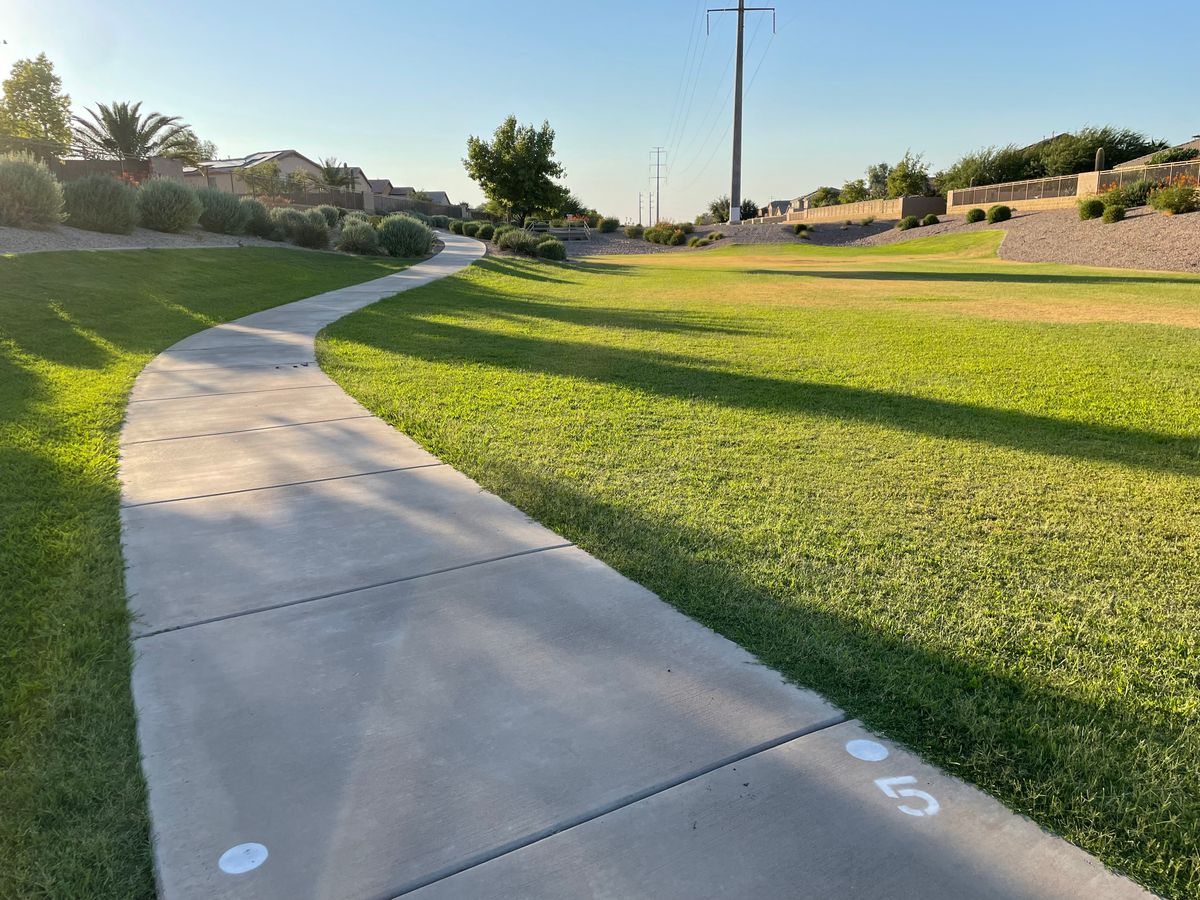 Hole 5. Big rocks and everything left of sidewalk OB. Basket in rocks above storm drain.