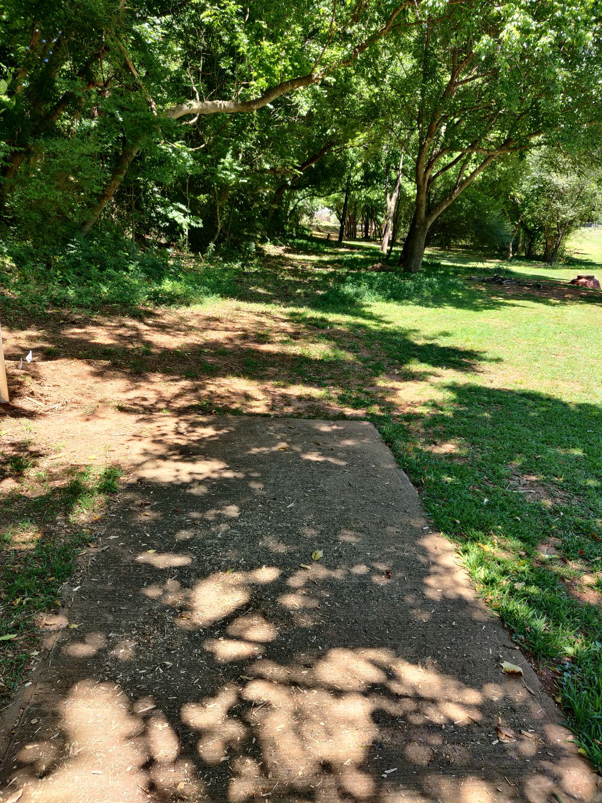 Hole 10. Old concrete pad. Looking down the fairway from the pad.