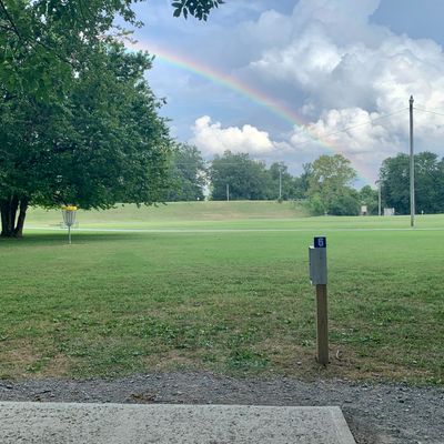 #6 tee pad with #2 basket and rainbow between rains in background