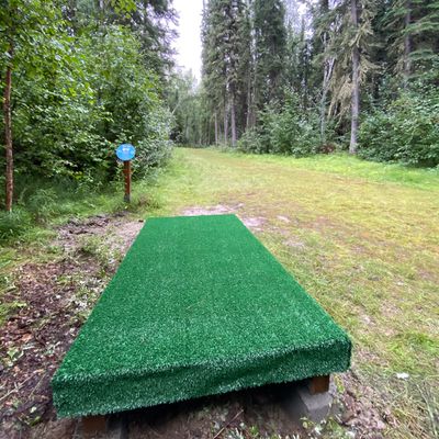 Hole 13 tee pad, basket at the end of the dog leg right