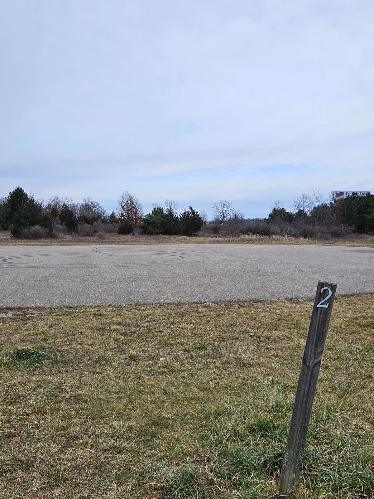 Basket 2, across drive, behind berm, left of brushy area