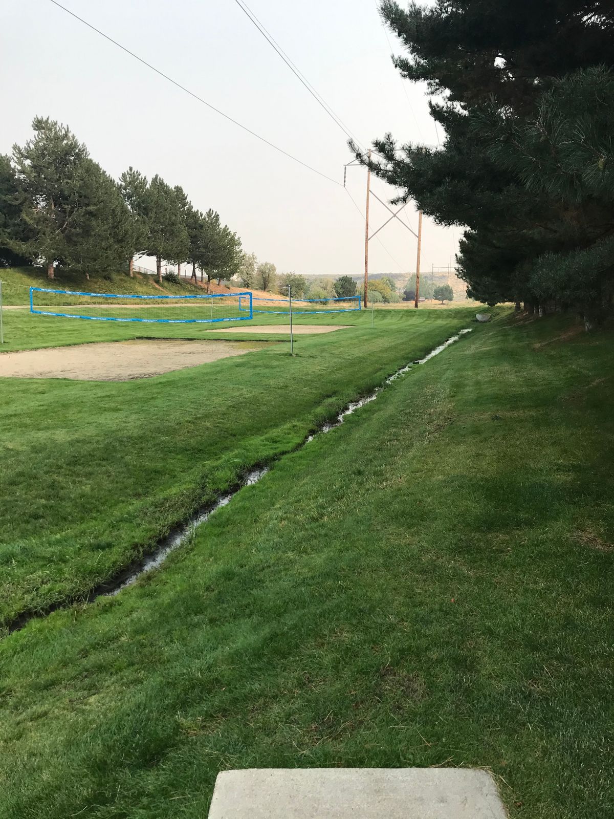 Hole 1: Basket is behind far corner of volleyball courts