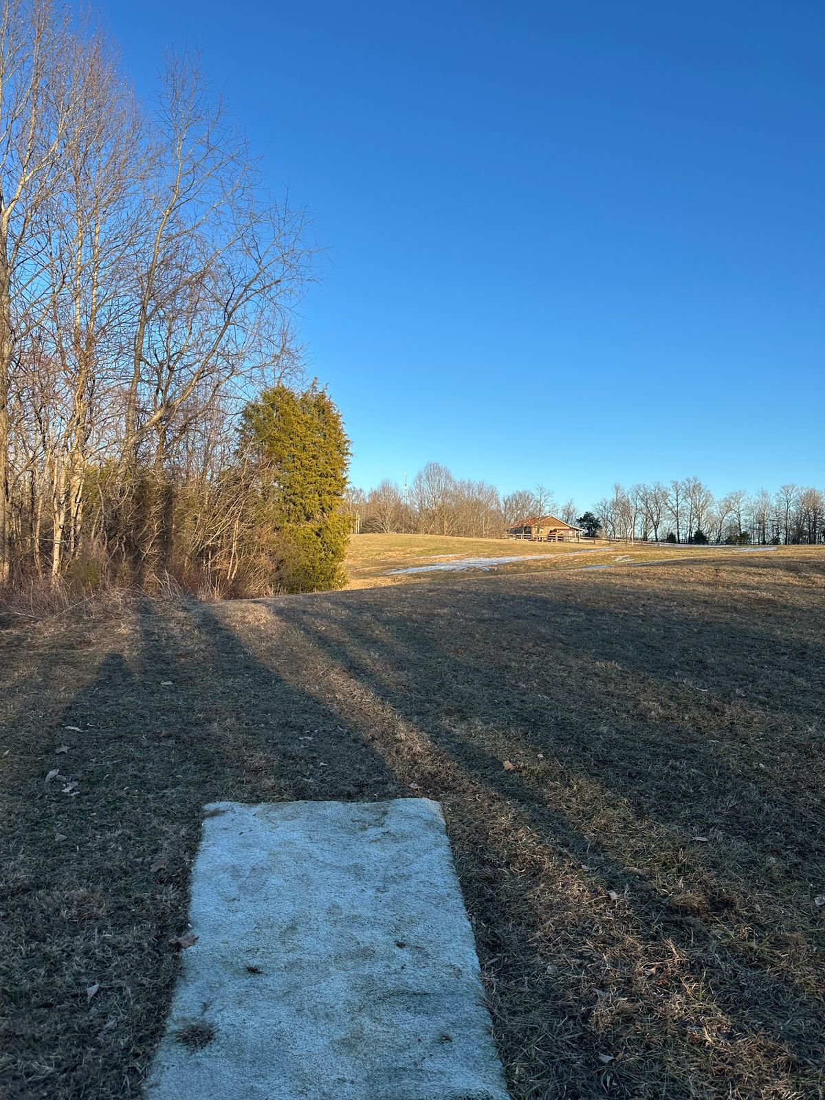Hole 9 tee pad, long deep over fence is OB.