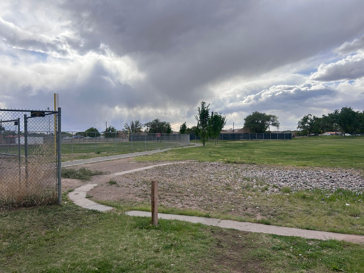 Hole 9 from tee area. Basket is past the red sign in the distance.