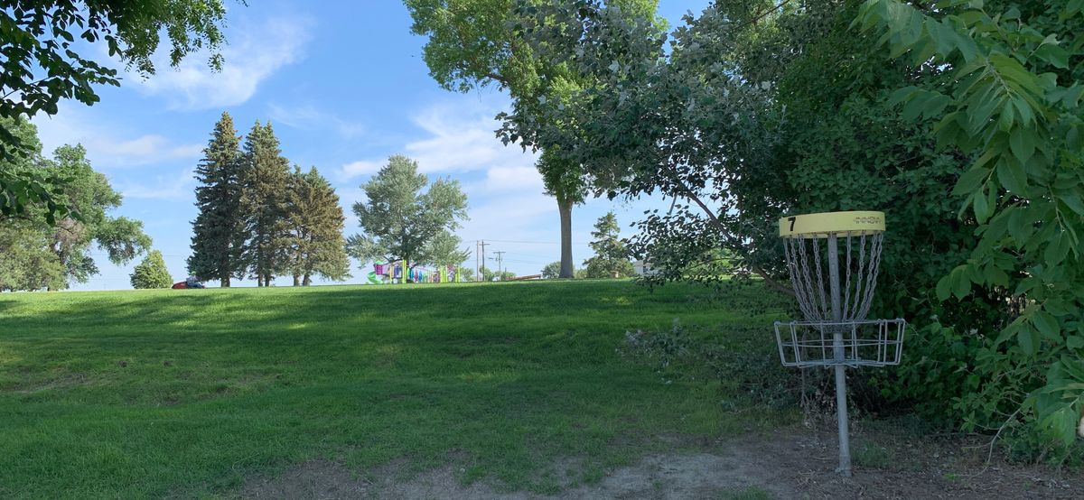 Hole 7…. Tee pad is just to the left of the playground when looking at basket
