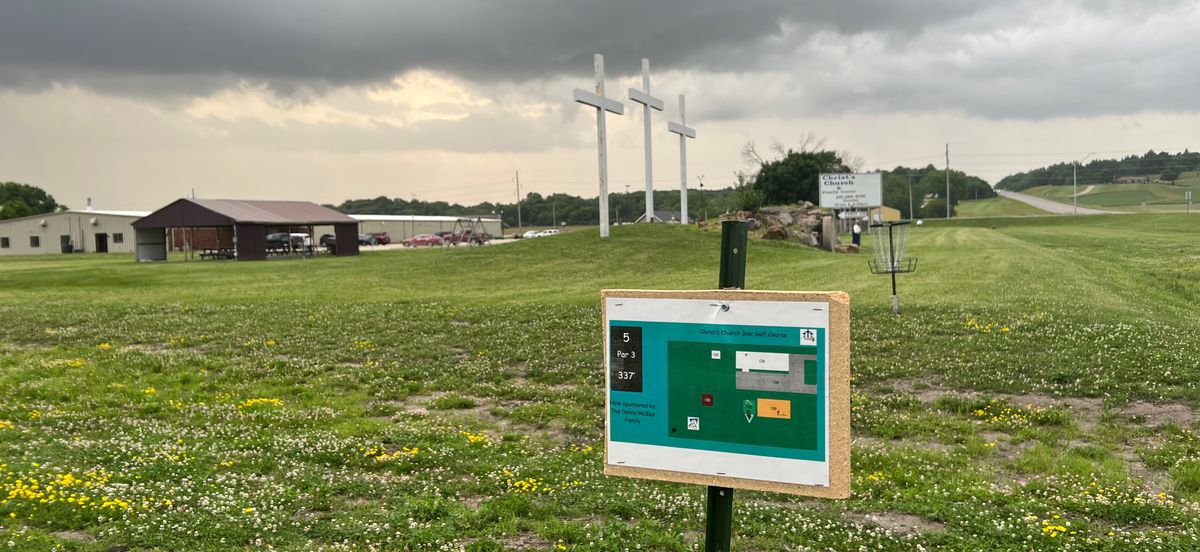 hole 5 sign/pad with crosses and clouds