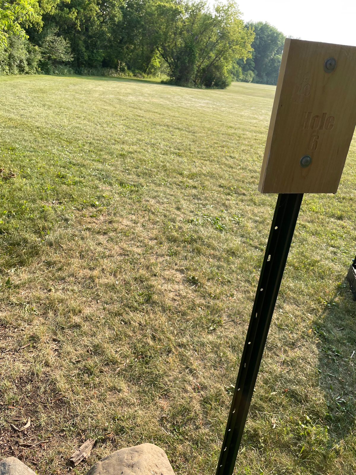 6 - Another hole with an earthen tee pad carved out. Plays to hanging basket in the grove of trees