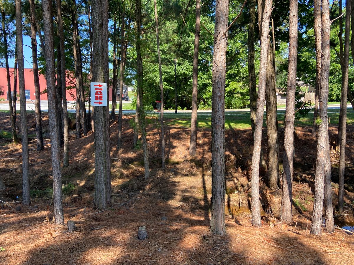 New Mando signage to the right down by the basket on par 4 9th hole.