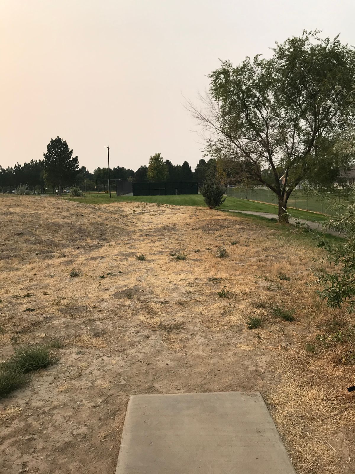 Hole 4: Basket is straight ahead in front of tennis court