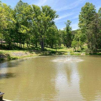 Start of the course. Hole 9 plays down the hill toward the right of the pond. Hole 1 tee is on left.