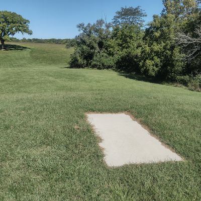 Hole 1 Tee. Basket around corner to the right.