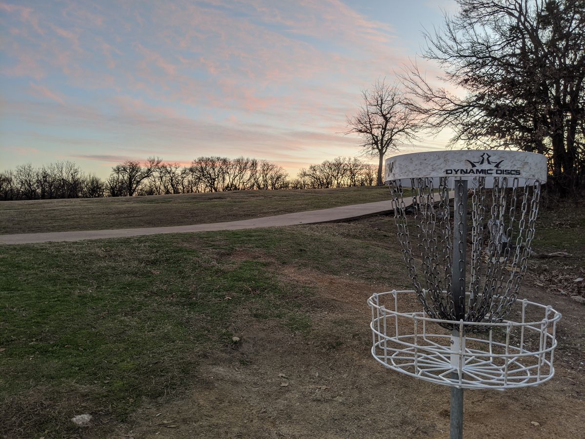 Hole 18 basket. Sunsets are one of the best reasons to play disc golf in Texas.