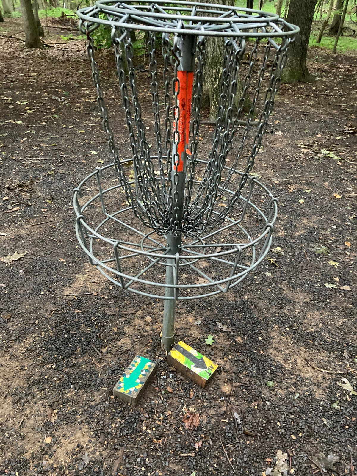 Each basket marks next tee pad(s) with hand painted bricks 🧱