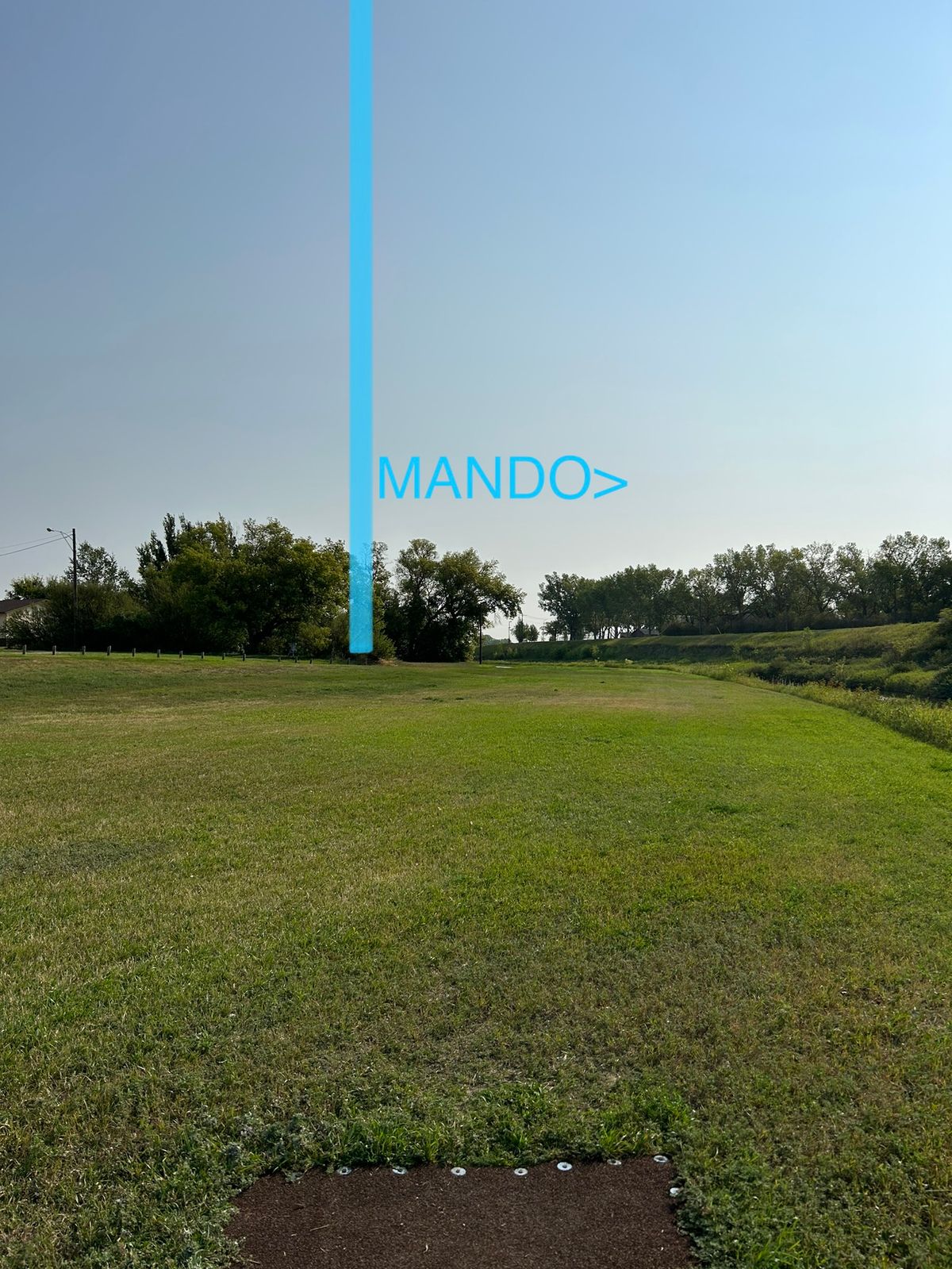 Hole 6 - road and beyond to the left OB. Disc must fly to the right of mando post (walking path IB)