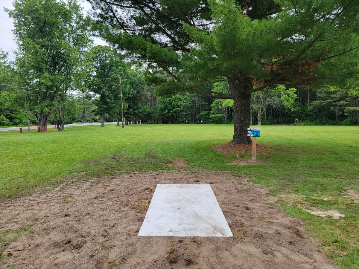 Hole 2s teepad, the basket is located just beyond the small knoll in the opening of the woods to slightly to the left of center.