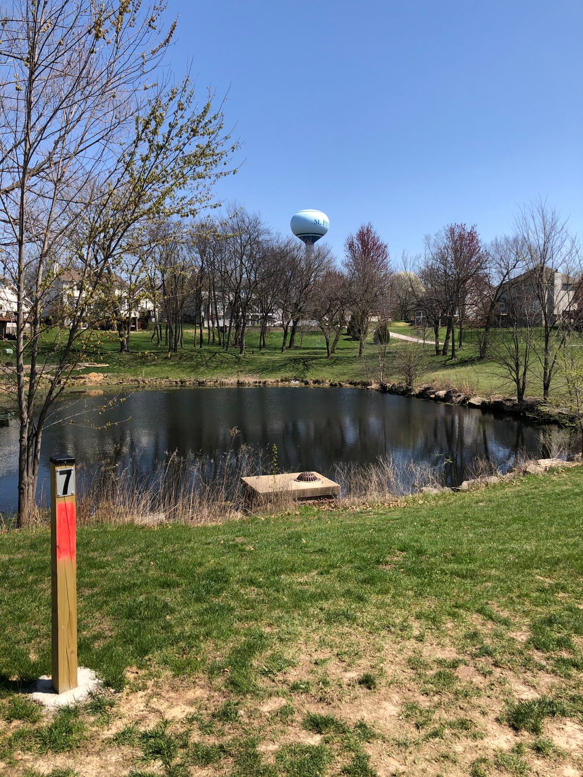 Hole 7 picturesque pond shot with water tower in background