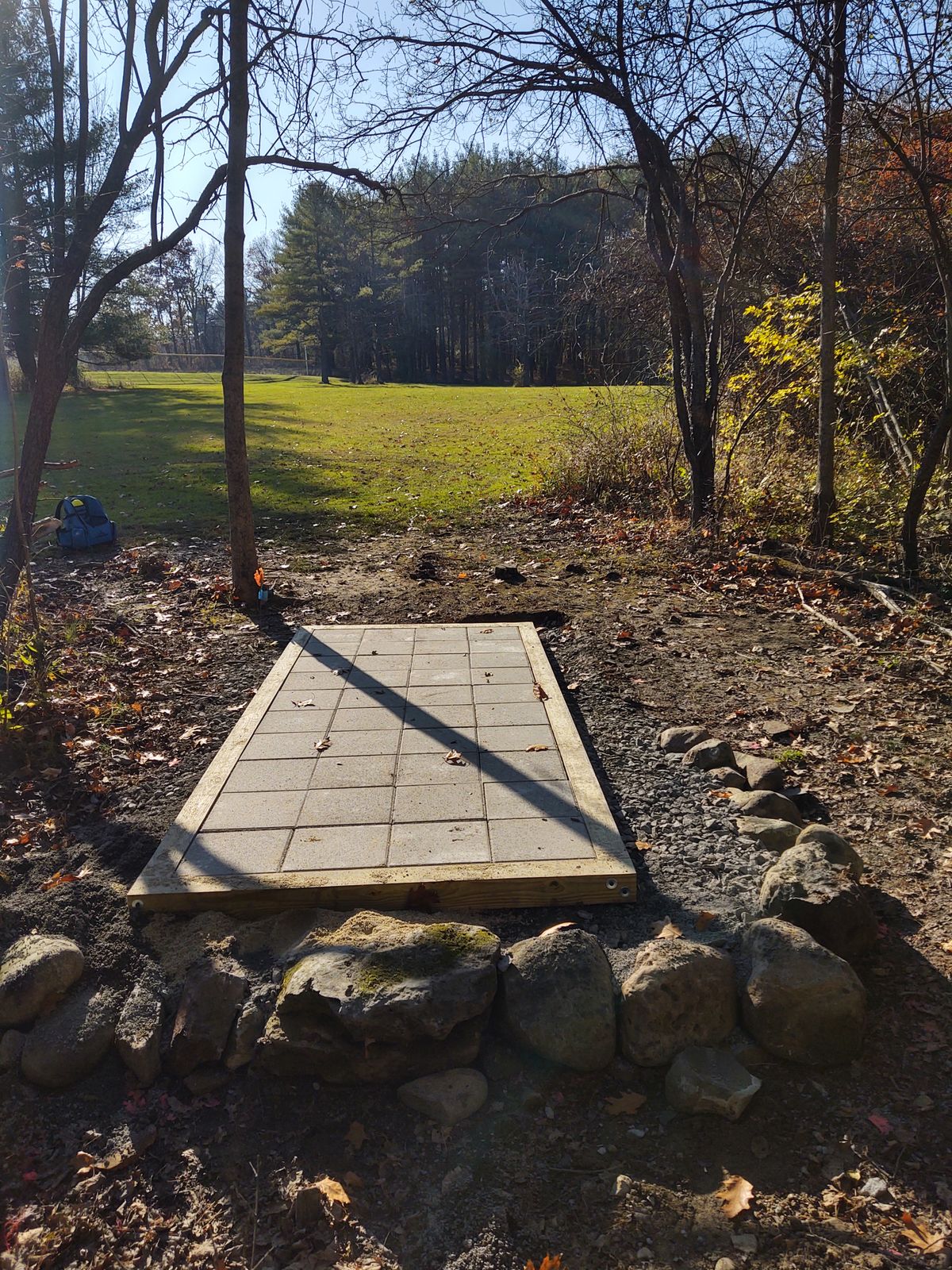 Hole 8 Back of Tee looking across field to basket in woods.