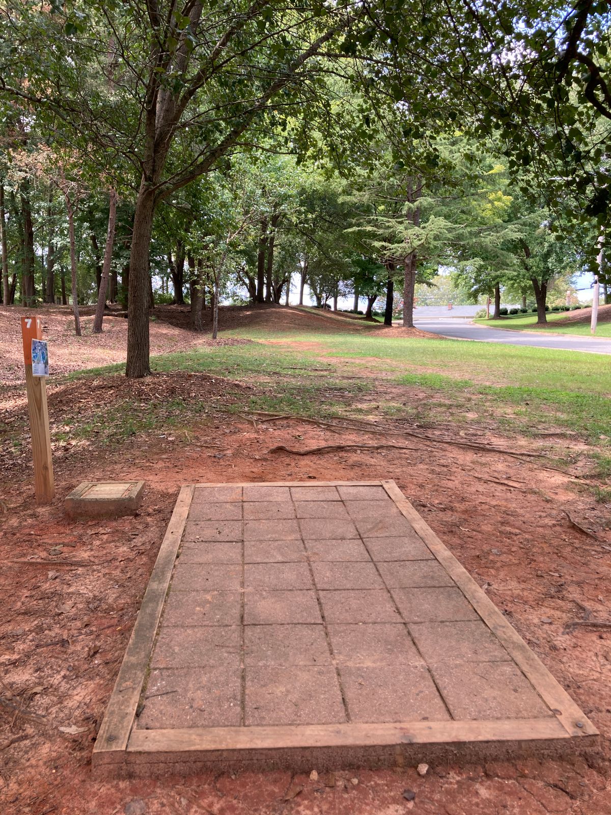 Hole 7 - straight shot plays 10-15 feet uphill - OB road and sidewalk on right.